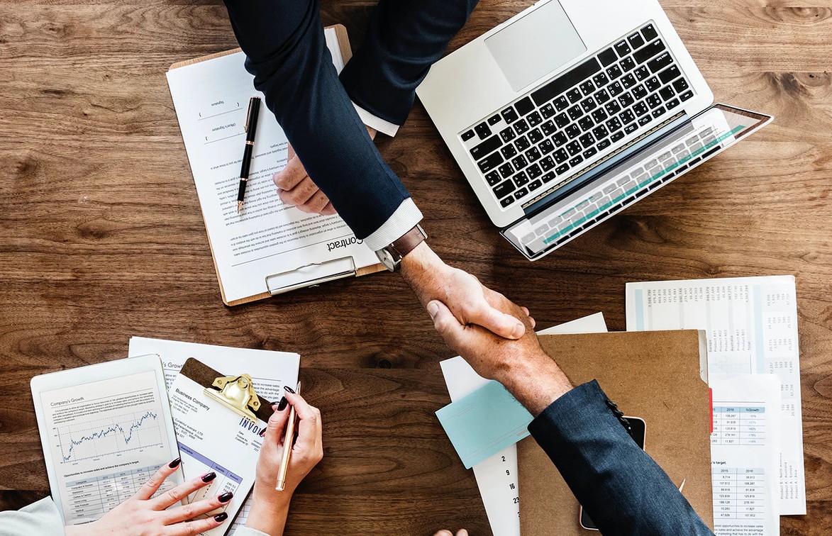 Business people shaking hands together Business people shaking hands together